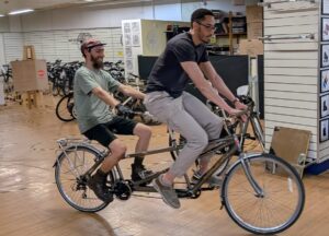 Tamden with 2 men riding it