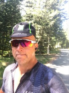 Male cyclist with trees in the background